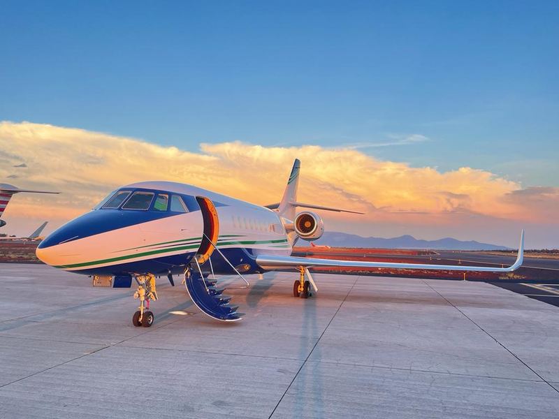 Business jet parked at dusk