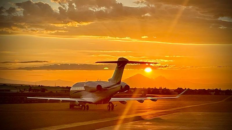 Business jet on the ramp at sunset